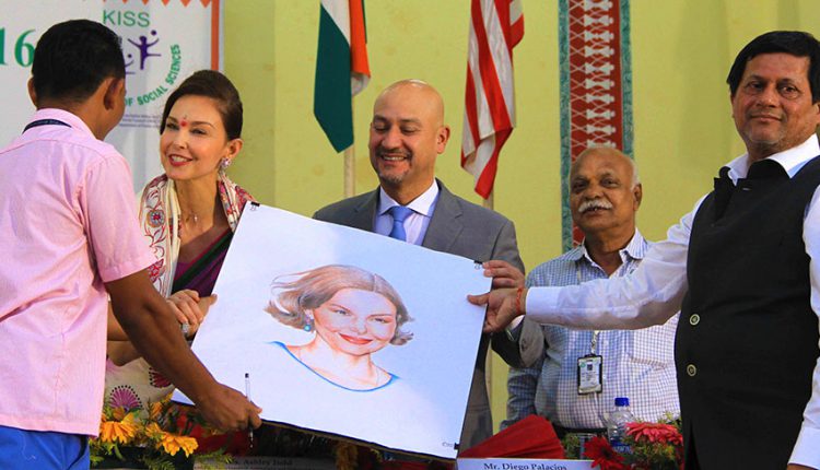 A student of KISS presenting a portrait to Ms. Ashley Judd.